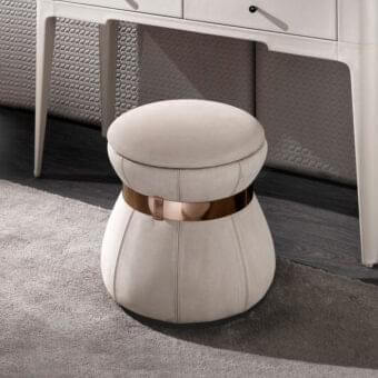 Innovative DV Home Collection Coco ottoman with a light beige fabric covering and refined steel insert