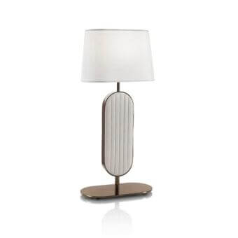 Elegant DV Home Collection Coco lamp with quilted light gold metal and a white fabric shade supported by a reflective base
