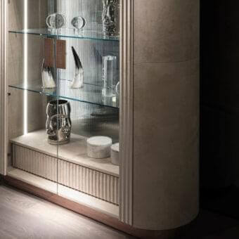 Distinguished DV Home Collection Hollywood Showcase cabinet with matt lacquered wood and steel edges, accented by Canneté finish and integrated lighting