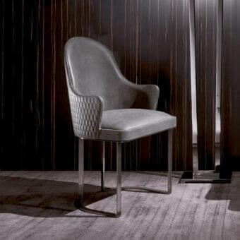 Distinguished DV Home Collection Deco armchair with medium-gray leather upholstery and polished steel base crafted with a hexagon quilted detail