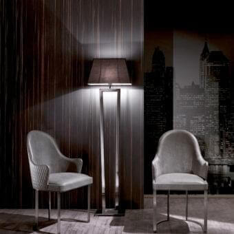 Distinguished DV Home Collection Deco armchair with beech plywood shell and light gray textile upholstery, built with a reflective metal base
