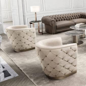 Elegant DV Home Collection Vogue lounge chair upholstered in light beige fabric with soft matte finish and gold-tone metallic base