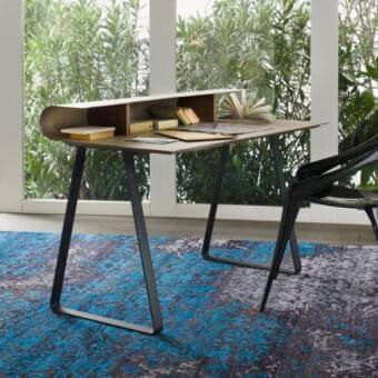Distinctive Reflex Twist desk with a leather-covered top and warm brown wood exhibiting a visible grain plus matte black metal legs