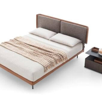 Elegant Ditre Italia Skin bed with light brown leather and greyish-brown fabric cushions, exhibiting a smooth finish
