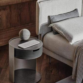 Distinguished Ditre Italia Skin nightstand with bent sheet metal support and veneered wood top covered in stylish bonded leather