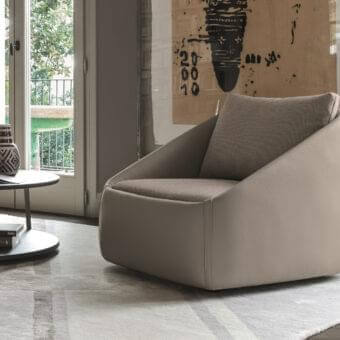 Sophisticated Ditre Italia Bend lounge chair fully upholstered in light taupe leather with soft geometric shapes and sartorial stitched corners