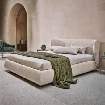 Elegant Ditre Italia Claire bed with textured light beige textile upholstery and curved wraparound headboard
