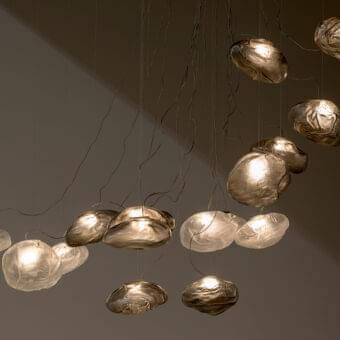 Exceptional Bocci 73 sculptural lamp with uniquely formed clear glass pendants and braided metal coaxial cables