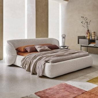Elegant Ditre Italia Clip bed with refined cream fabric upholstery and curved sculptural form