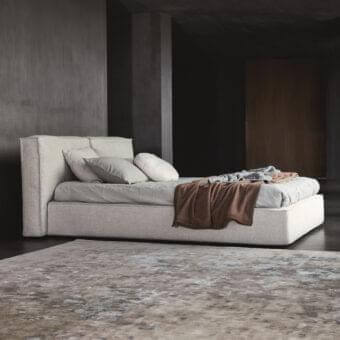 Distinguished Ditre Italia Flann bed with pinewood structure and light beige textile upholstery exhibiting a textured matte finish