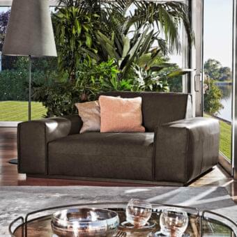 Sophisticated Ditre Italia Monolith lounge chair with dark brown textile and light brown peach cushions offers a harmonious design