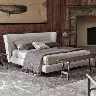 Elegant Ditre Italia Royal bed upholstered in light beige textured textile with a gently sloping headboard