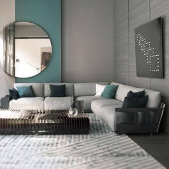 Exclusive Giorgetti Adam sectional with light gray fabric upholstery, pewter painted metal and dark green decorative cushions