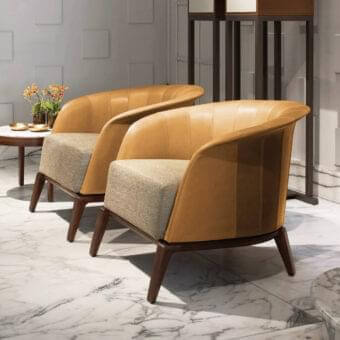 Distinguished Giorgetti Aura lounge chair with solid canaletto walnut frame, honey-brown leather backrest and light-brown textured fabric seat