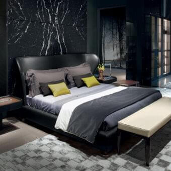 Distinguished Giorgetti Rea bed with winged shape and embracing curved black upholstery in sleek material with polished pau ferro feet