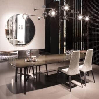 Exclusive Giorgetti Rift mirror with round reflective surface and solid ash wood frame accented with bronze painted metal dividers