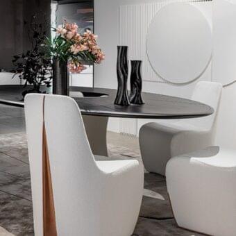 Exceptional Giorgetti Tie chair with full volume, textured white fabric upholstery and contrasting brown leather detail