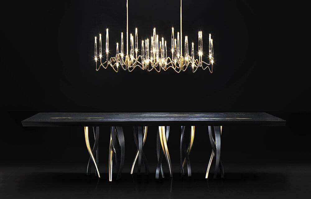 Lavish Il Pezzo 3 Long Chandelier lighting built with hand-forged brass and clear solid crystal diffusers in radiant gold finish