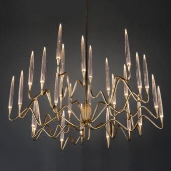Lavish Il Pezzo Mancante chandelier built with hand-forged brass and clear solid crystal illuminated with glossy gold finish
