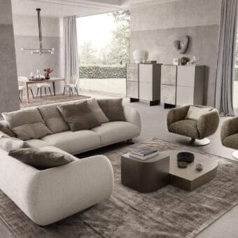 Elegant Presotto Bali sectional built in light beige woven fabric with Peltro painted legs and multiple brown throw pillows