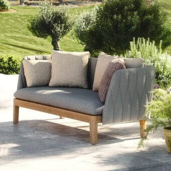Sophisticated Royal Botania Calypso lounge sofa with durable teak base and neutral gray woven fabric upholstery