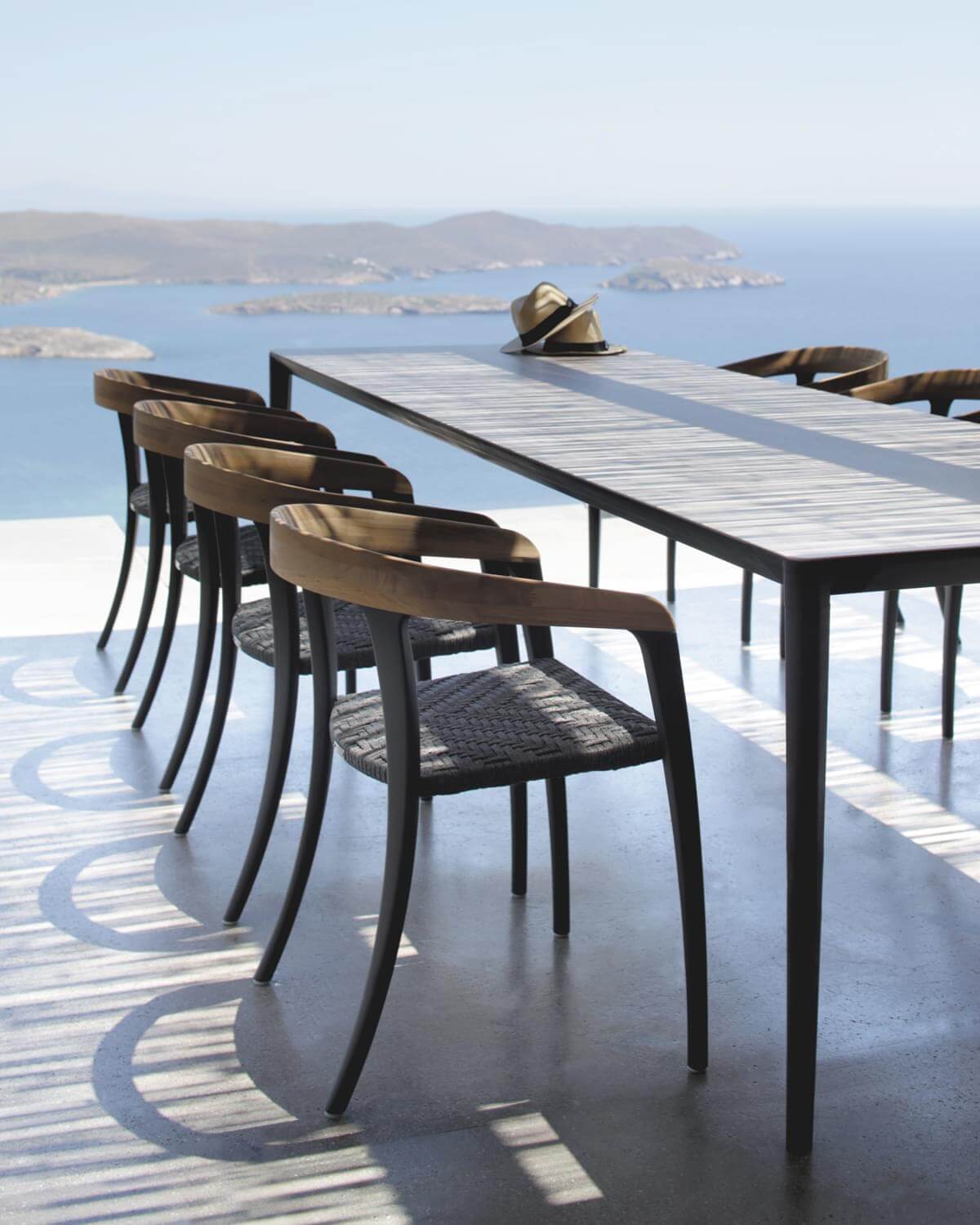 Harmonious Royal Botania Jive armchair built with tapered aluminum, teak, and a woven olefin seat offering a balanced aesthetic