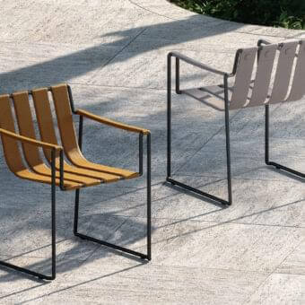 Elegant Royal Botania Strappy armchair with tan seat straps and dark finished coated stainless steel frame