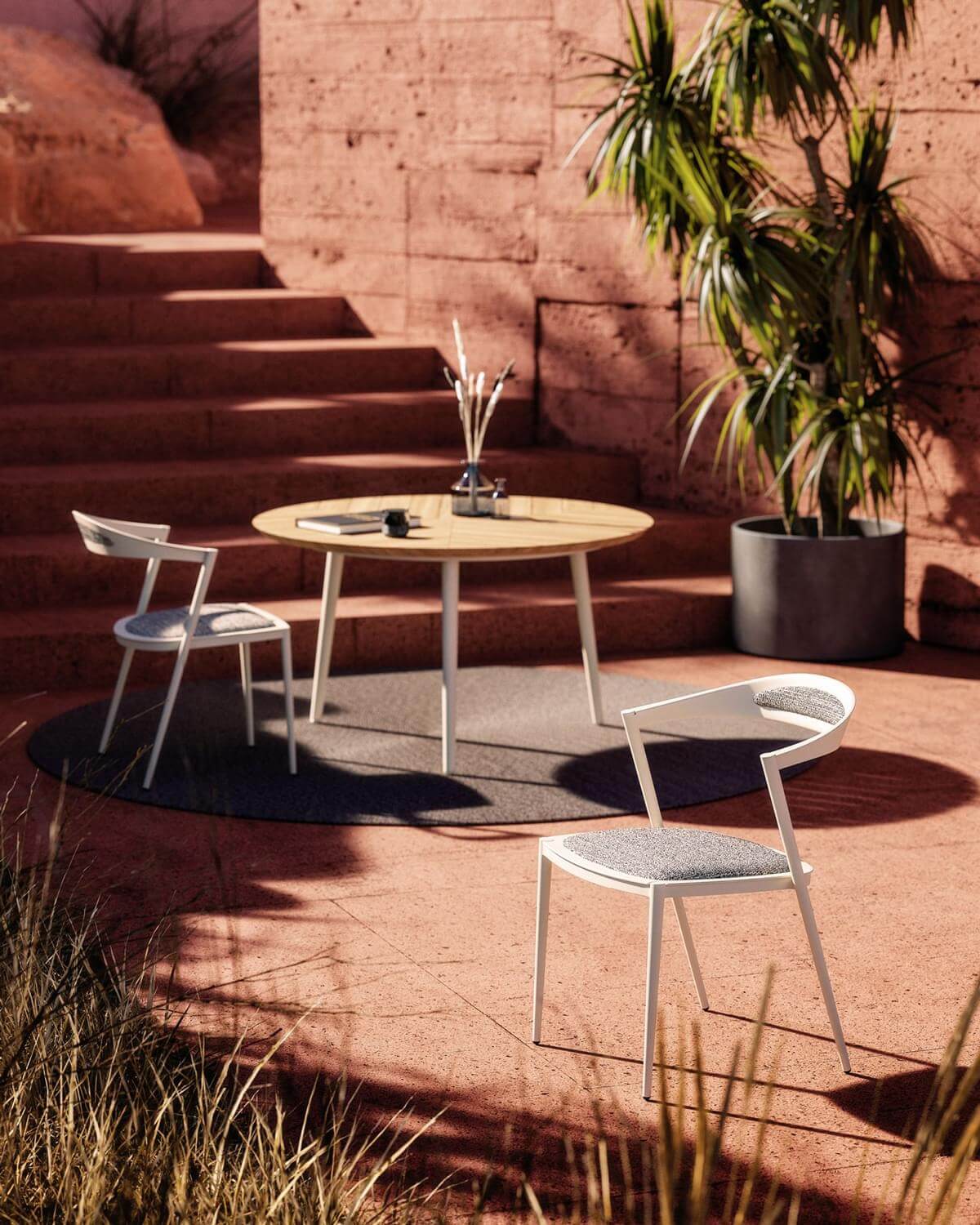 Innovative Royal Botania Styletto chair with sleek white aluminum framing and gray textile padding for comfortable outdoor use