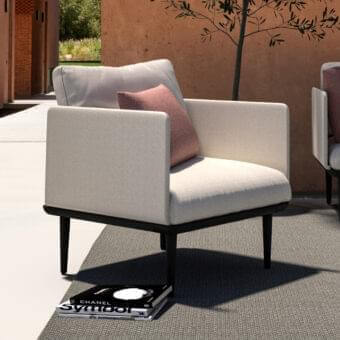Sophisticated Royal Botania Styletto lounge chair with tapered coated aluminum legs and light beige fabrics with a pink cushion