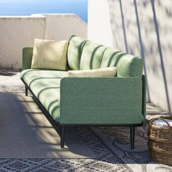 Distinguished Royal Botania Styletto lounge sofa with dark coated aluminum and lush green textured upholstery complemented by beige cushions