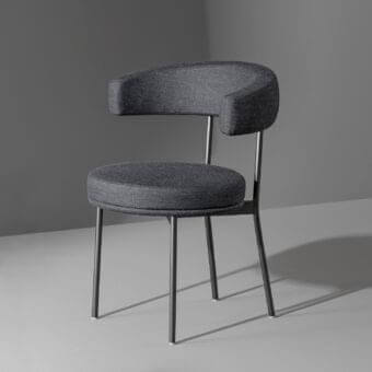 Elegant Bonaldo Neuilly armchair with dark grey matte fabric and slender metal legs offering a comfortable embrace