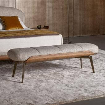Sophisticated Bonaldo Olos bench with light gray padding and woven textile, complemented by curved Canaletto Walnut wood with matte bronze metal legs