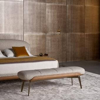 Sophisticated Bonaldo Olos bench with light gray textured textile and curved Canaletto Walnut wood detail in bronze metal legs