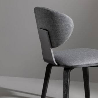 Elegant Bonaldo Olos chair with balanced design, woven gray fabric upholstery and coal ash wood frame