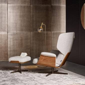 Sophisticated Bonaldo Olos lounge chair with light gray textile upholstery and curved Canaletto Walnut wood structure