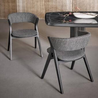 Distinguished Bonaldo Remo chair with curved back and comfortable cushioning in textured gray fabric with coal solid ash wood legs