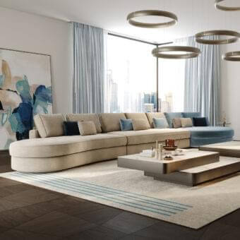 Sophisticated Reflex Adone sectional with rounded shapes upholstered in beige textile and goose feather cushions