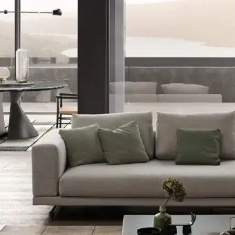 Distinguished Presotto San Marino sofa with light gray subtly textured textile and peltro varnished metal feet, accented with green cushions