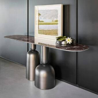 Innovative Bonaldo Cop console with red-brown marble top and reflective metal sculptural pedestals