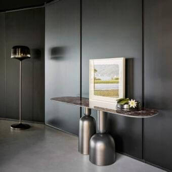 Refined Bonaldo Cop console with brown marble-like top and satin finish dark metal pedestals