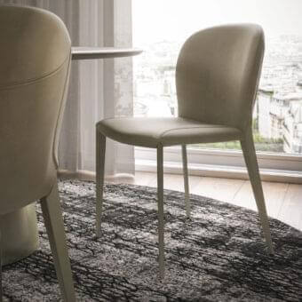 Elegant Cattelan Italia Nancy ML chair with light beige or grey upholstery and curved lines built with slender steel legs