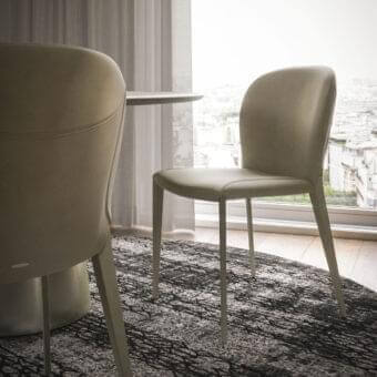 Elegant Cattelan Italia Nancy ML chair with light beige upholstery and slender matte steel legs exhibiting sinuous forms