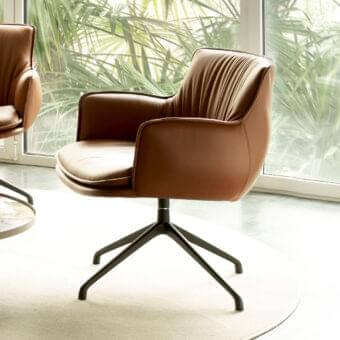 Captivating Cattelan Italia Rhonda lounge chair with curved brown leather upholstery and sleek black metal base