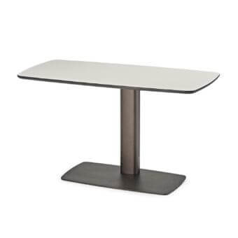 Light toned horizontal plane above a dark cylindrical support and rectangular base with clean geometric forms