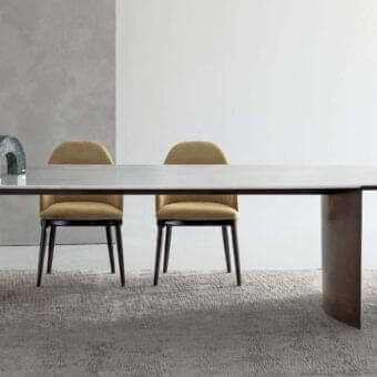 Distinguished Rugiano President table with light gray stone-like surface and varnished bronze curved legs