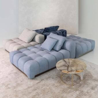 Sophisticated Rugiano Yacht sectional with quilted dusty blue textile and light gray sections, built with refined metal details