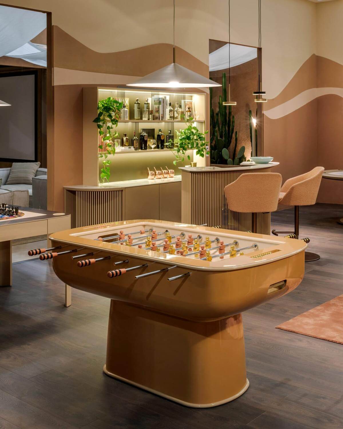 Elegant Vismara Oskar foosball table with glossy caramel lacquered structure and precision-turned beige aluminum players on tempered glass
