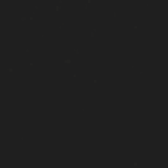 Dark gray matte surface with scattered irregular light gray and white speckles distributed across the field