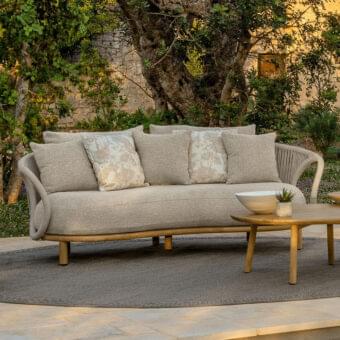 Stylish Talenti Karen sofa embodies a tribal aesthetic with enveloping shapes and curved lines in light beige textured textile with integrated rope armrests