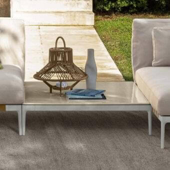 Superior Talenti Salinas coffee table with light-colored lava stone and a light gray metal base